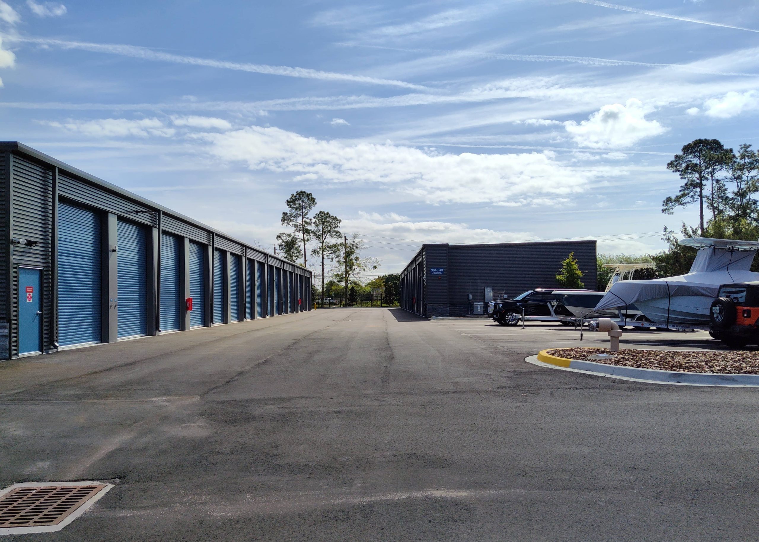 Outside drive-up storage units on the left and to the right shows outdoor vehicle parking with RVs, Boats, Cars, and Trucks present