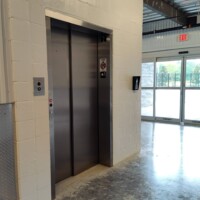 Elevator for accessibility to upper level storage units