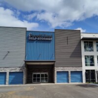 Front entrance to the storage facility with blue drive-up units on the ground floor and two additional floors of indoor storage