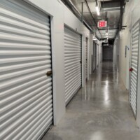 Hallway of indoor storage units with white doors
