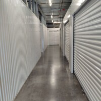Hallway of indoor storage units with white doors