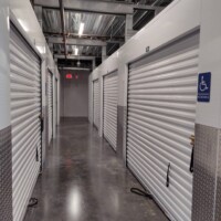 Hallway of indoor storage units with white doors