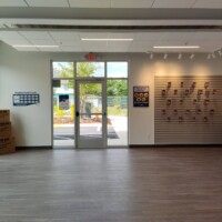 The view of the entrance from inside the building. On either side of the wall are the moving supplies for sale including boxes, locks, tape, and more