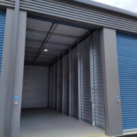 Outdoor storage unit with bluetooth access open to show the inside of the these drive-up units