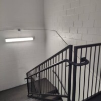 Staircase leading down to lower and ground level storage units